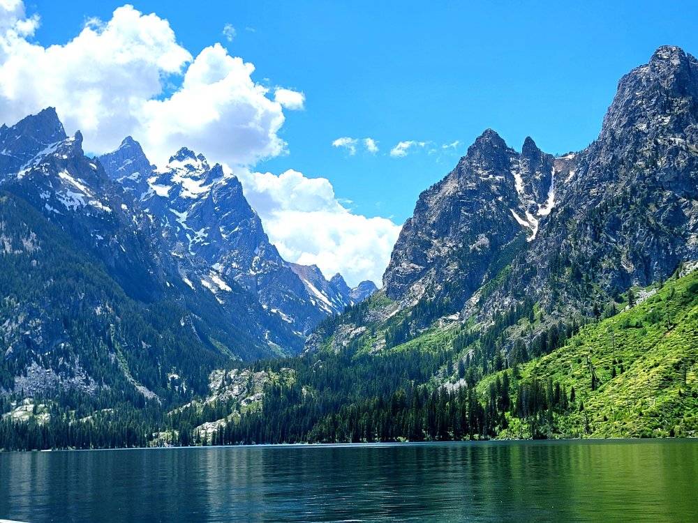 Teton mountains rising above a calm alpine lake in Grand Teton National Park