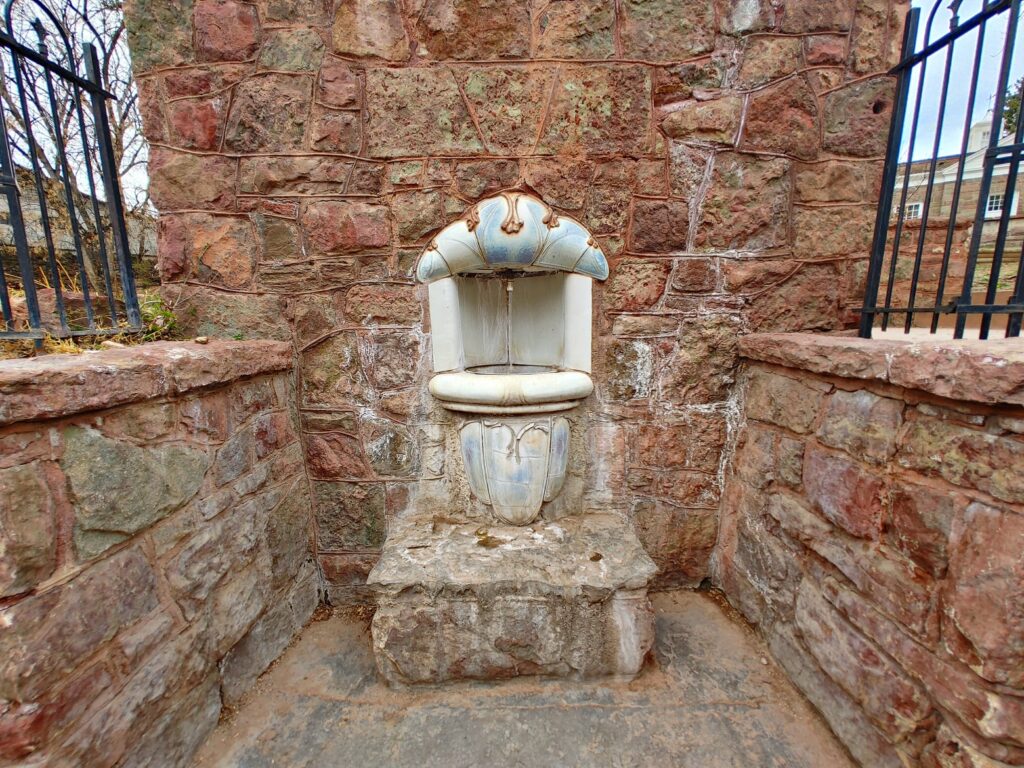 Historic Manitou Mineral Springs fountain built into stone wall