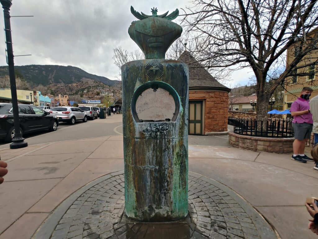 Decorative mineral spring fountain along downtown Manitou Springs sidewalk