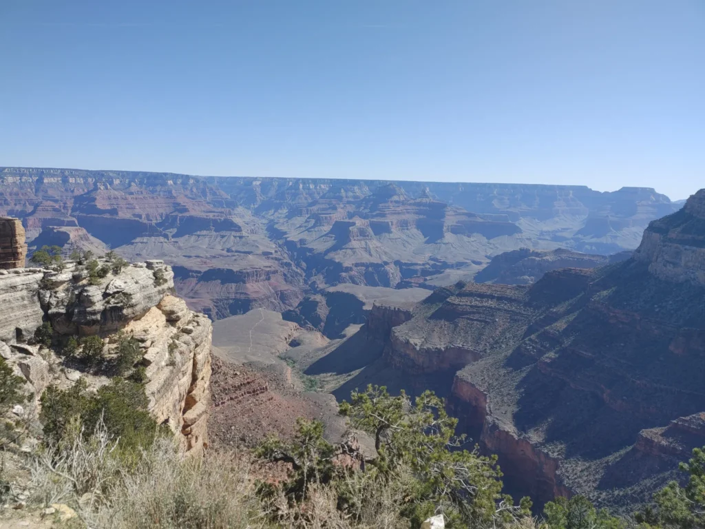 the dramatic cliffs and valleys of Grand Canyon national park against a clear blue sky background 