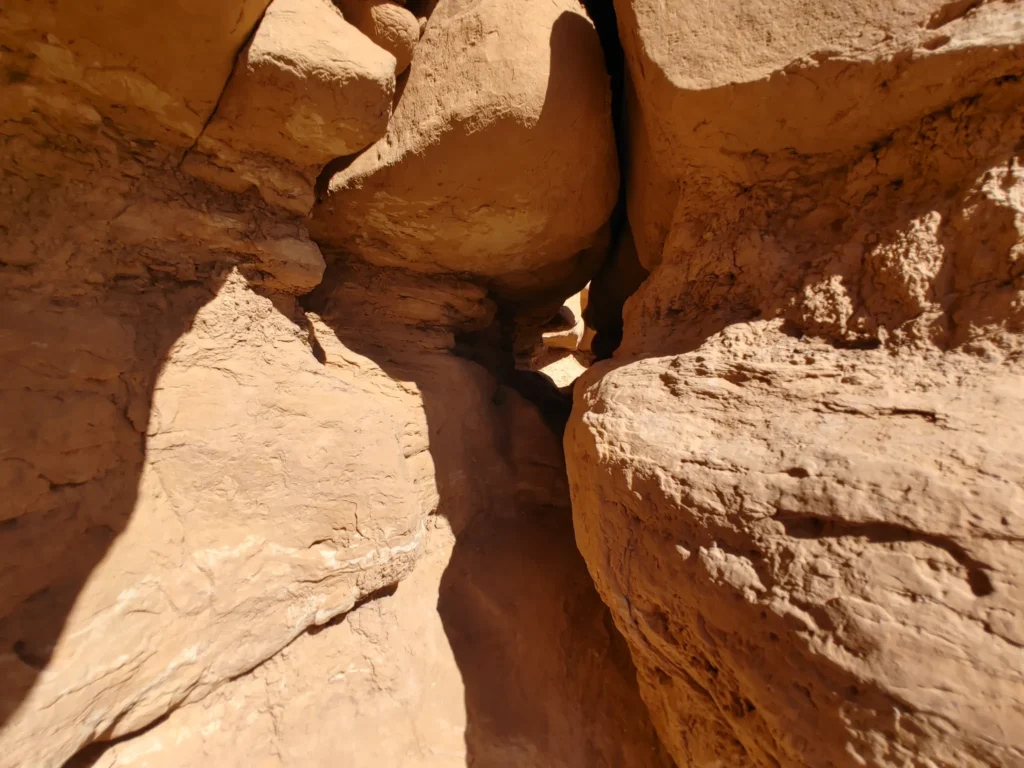 Narrow sandstone passage, between rock formations, one of the best things to do in Goblin Valley State Park with kids 