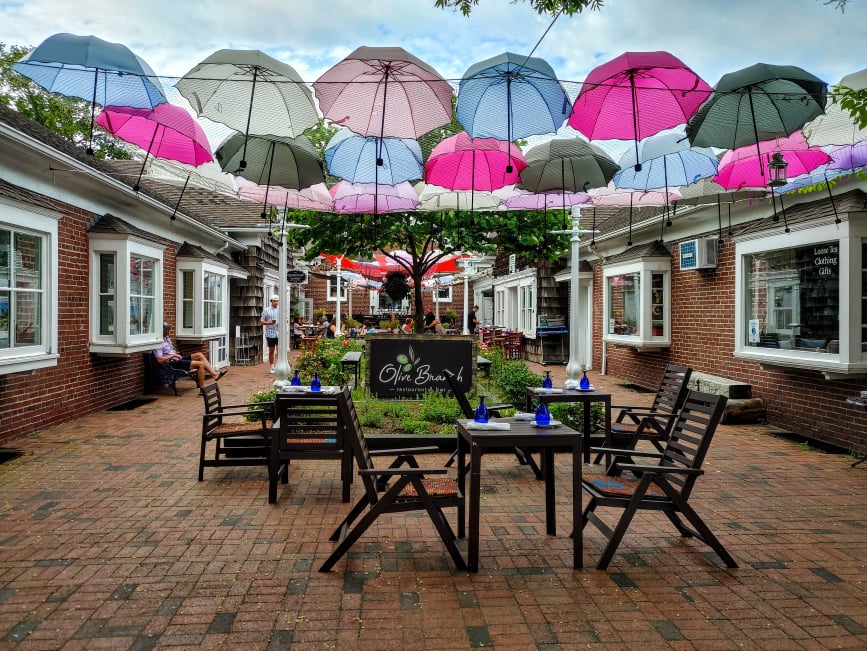 Colorful umbrellas hanging above outdoor seating in Greenport Village on Long Island’s North Fork.