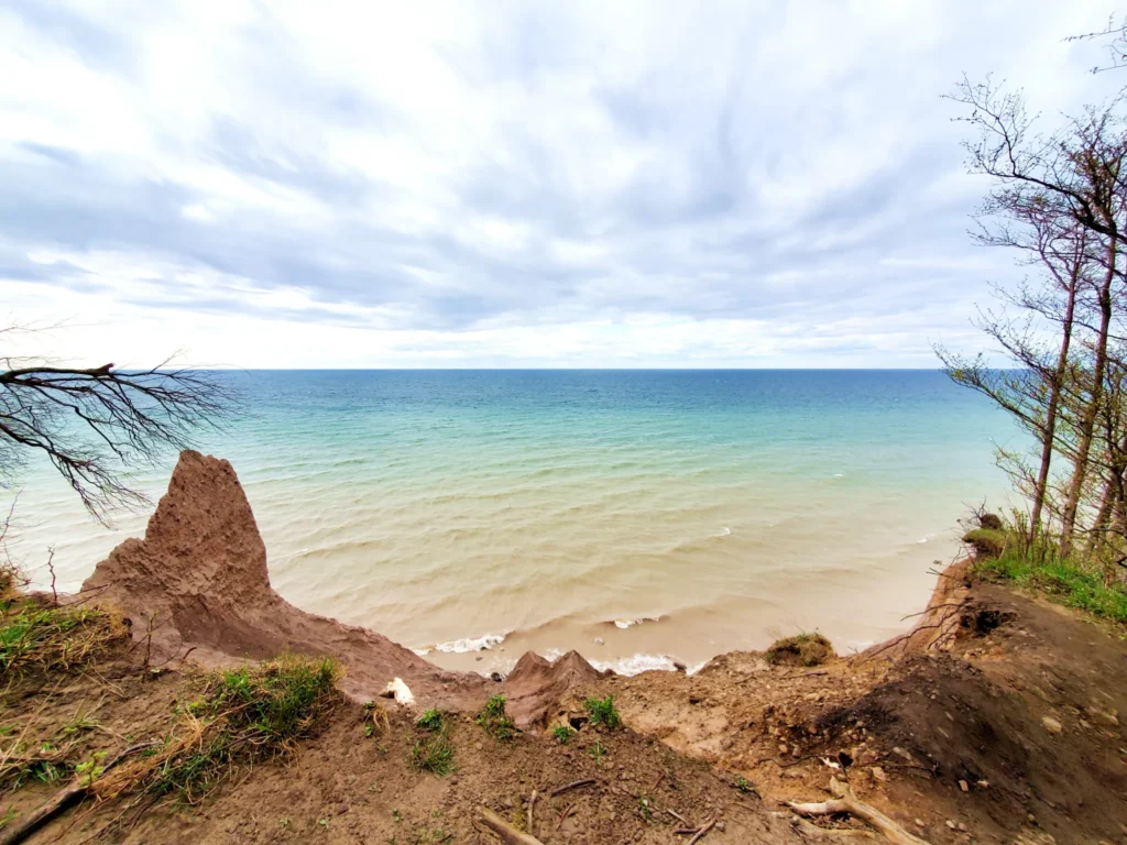View from Chimney Bluffs State Park overlooking Lake Ontario and dramatic eroded cliffs.