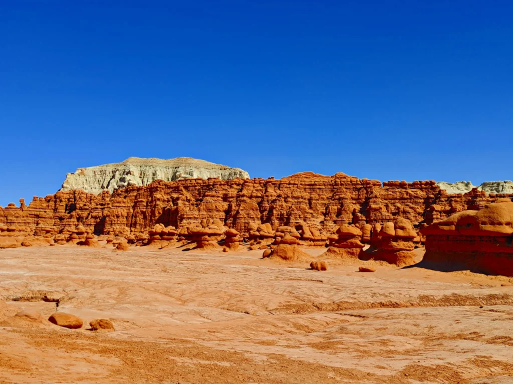 Red rock hoodoos and desert cliffs at Goblin Valley State Park, Utah.