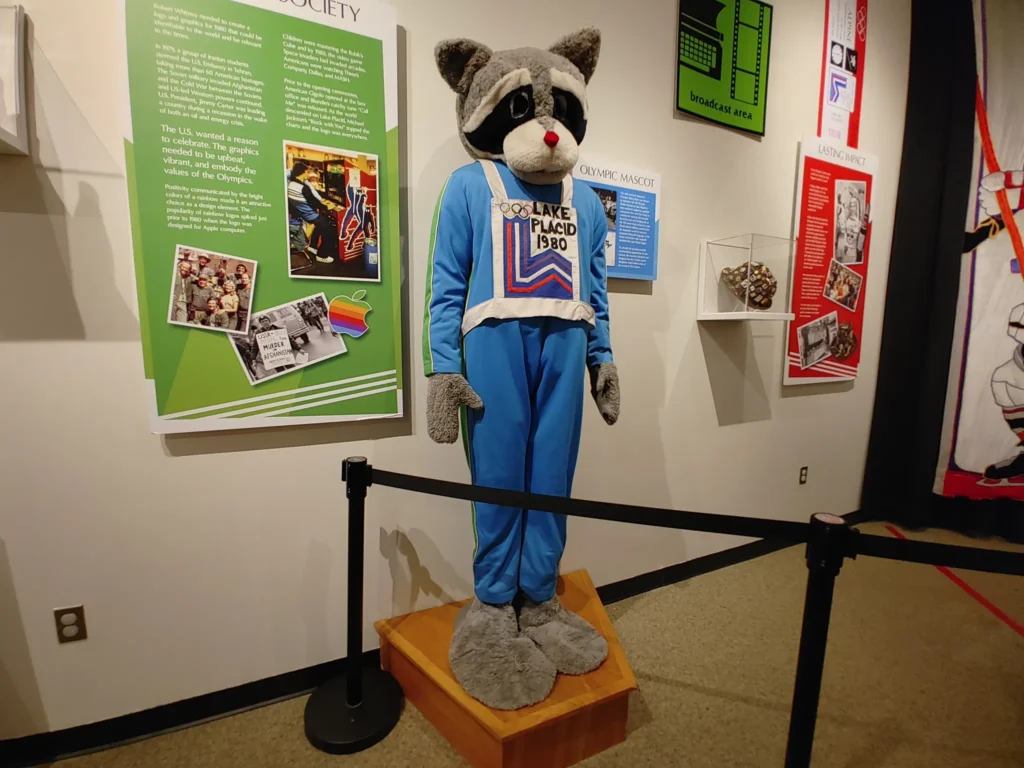 Lake Placid 1980 Olympic mascot display inside a museum exhibit featuring Winter Olympics history and memorabilia.