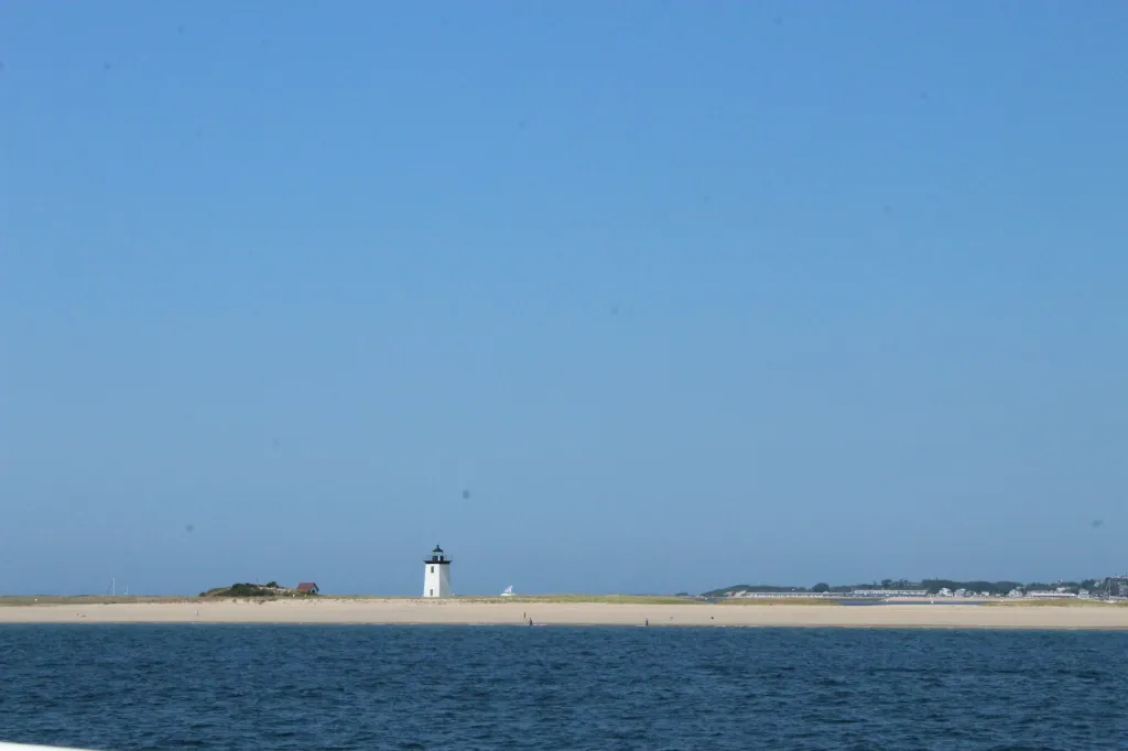 Long Point Lighthouse standing along the sandy shoreline near Provincetown
