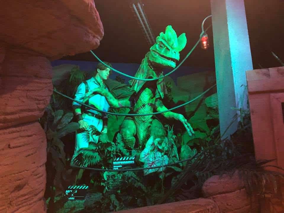 Dinosaur-themed wax figure exhibit inside a Niagara Falls attraction featuring prehistoric scenery and dramatic lighting.