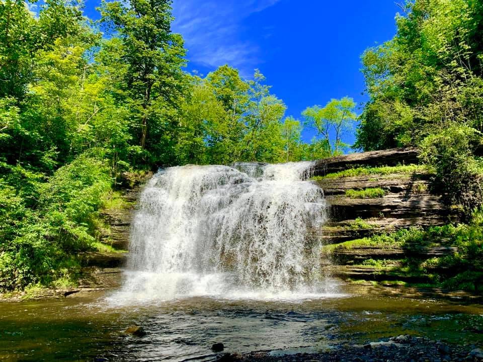 Pixley Falls waterfall flowing over a wide rock ledge, one of the best New York State parks with waterfalls