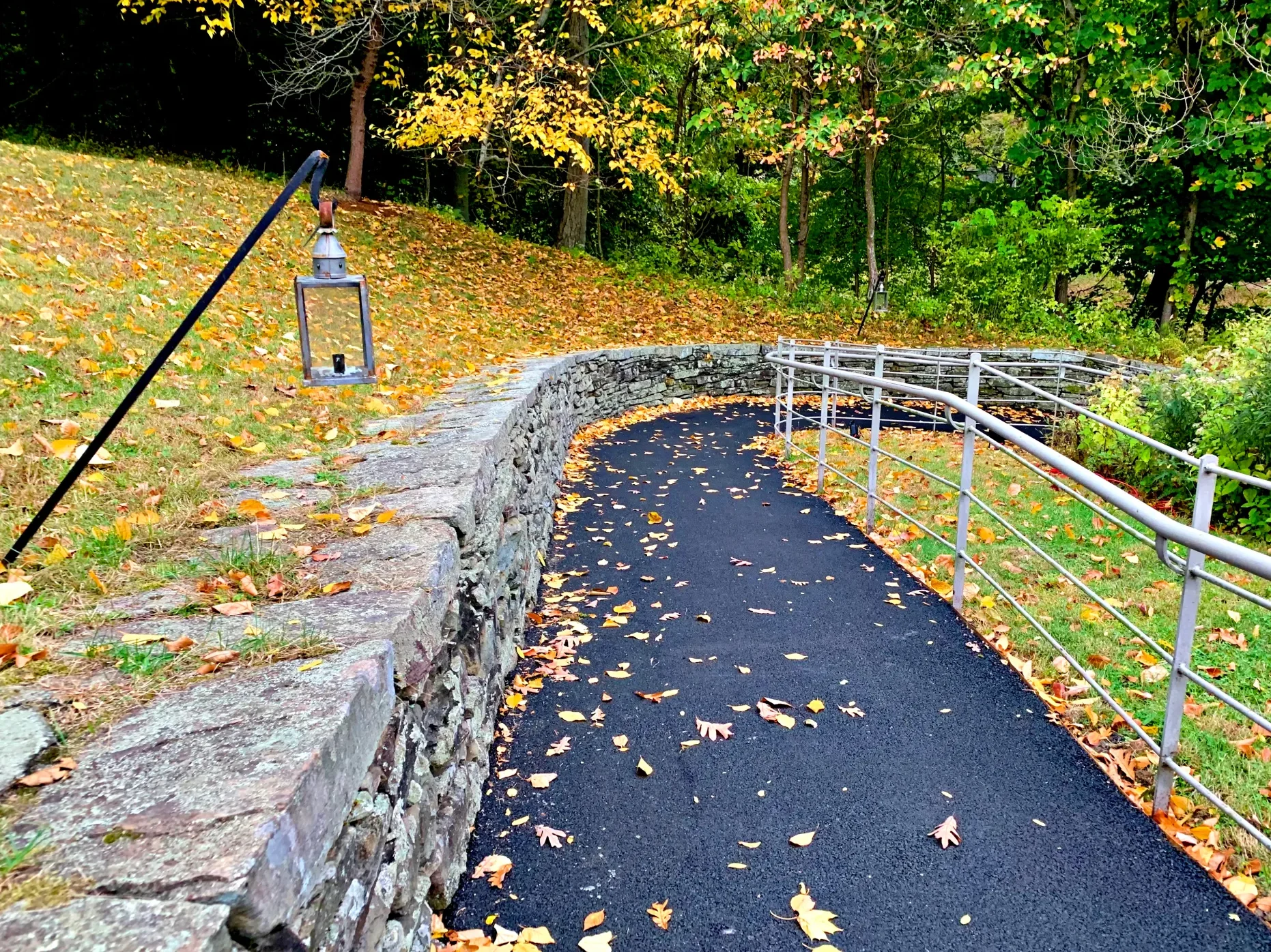 a paved path covered with fallen leaves heading to Irving's Sunnyside home, one of the best attractions in sleepy hollow, NY