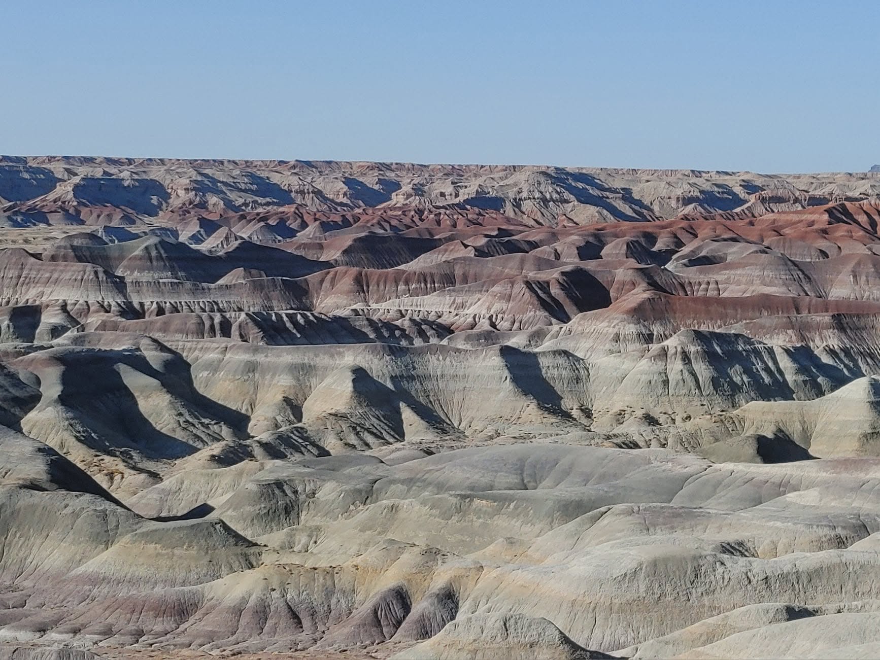 Colorful striped hills and layered badlands in the Painted Desert of Arizona.