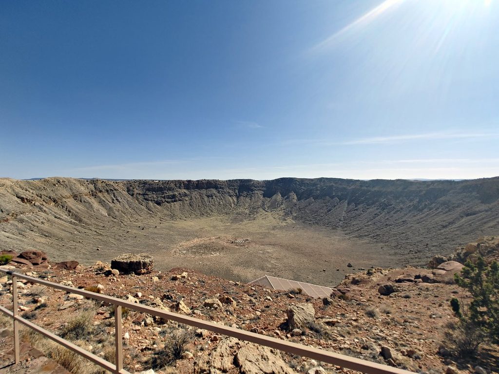 Meteor Crater in Arizona, a massive impact crater surrounded by a rocky desert landscape.
