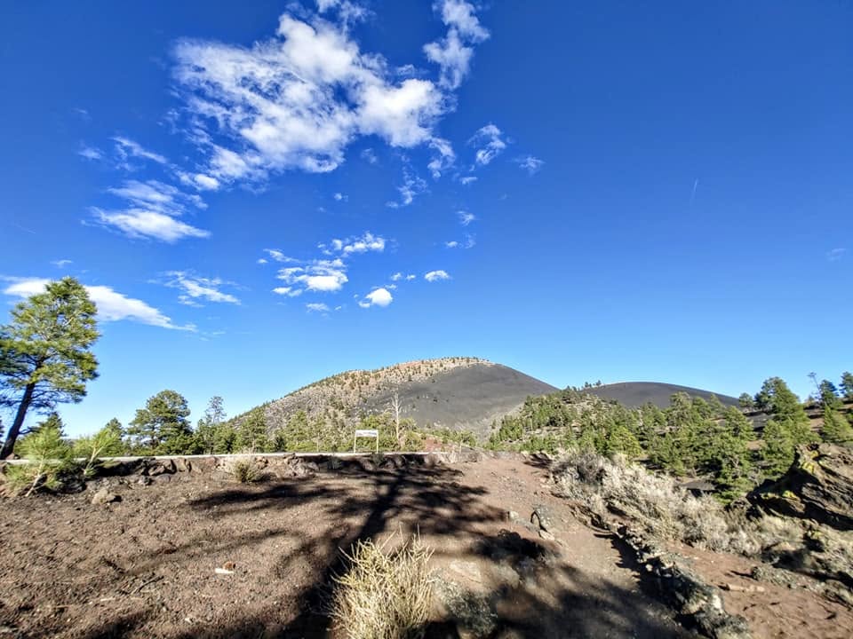 Scenic mountain landscape surrounded by pine trees at Sunset Crater Volcano National Landmark